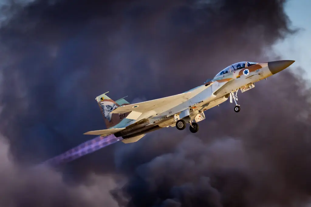 Military jet flying with smoke background