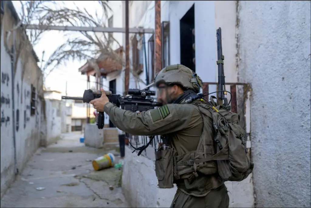 Armed soldier in urban alleyway, on duty