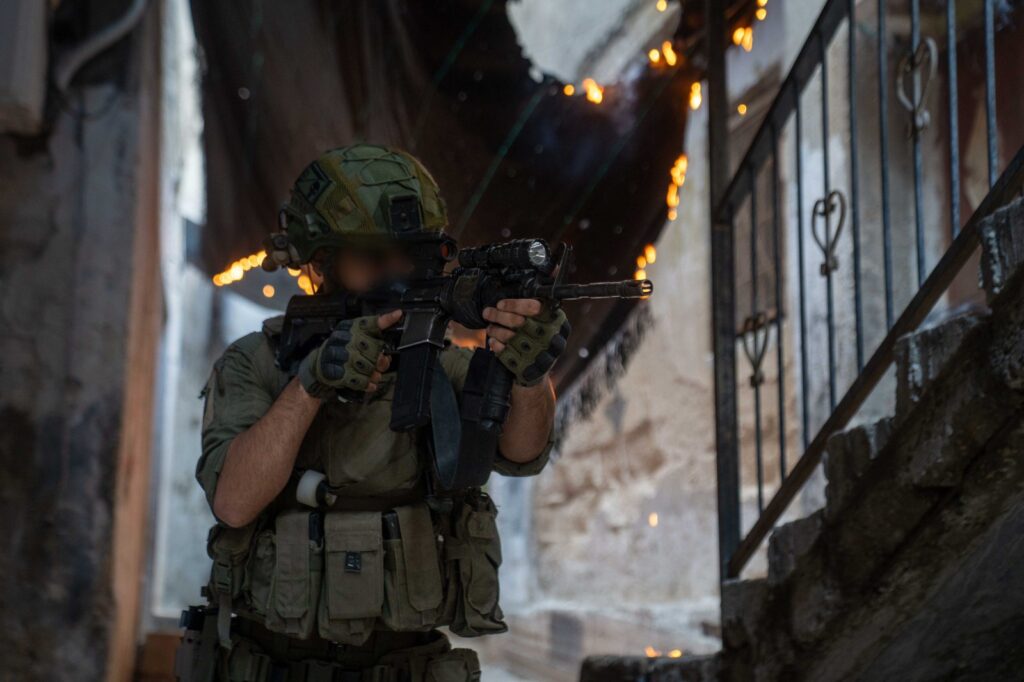 Armed soldier aiming in urban setting.