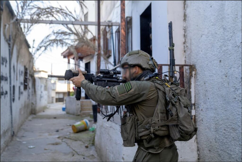 Armed soldier in urban alleyway, on duty