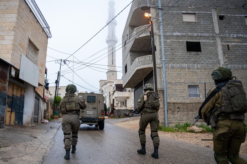 Three soldiers walking in urban area street