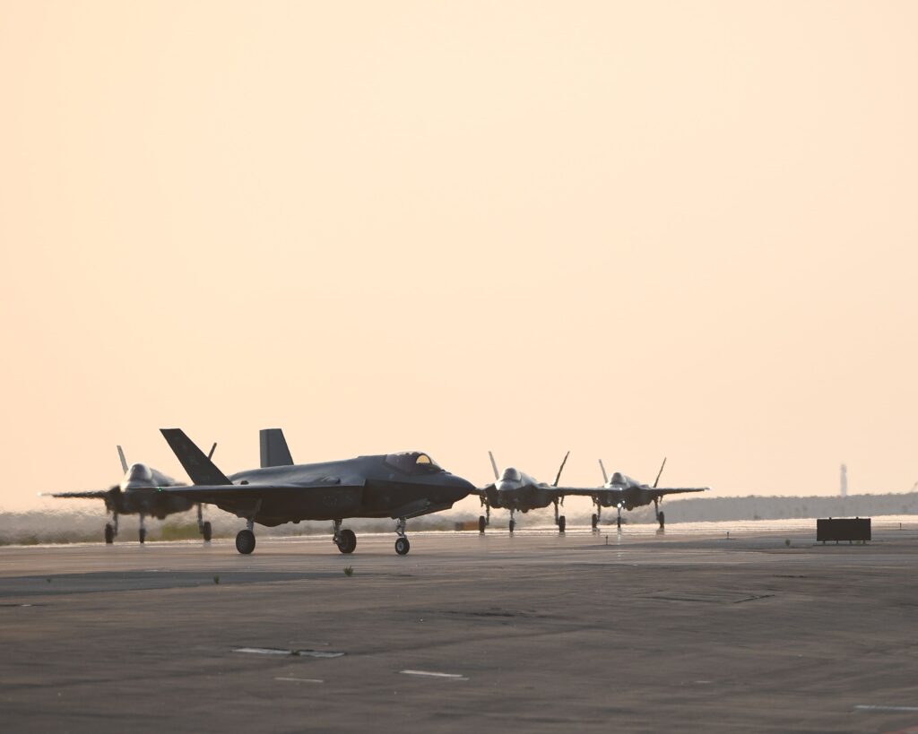 Fighter jets taxiing on runway at sunrise